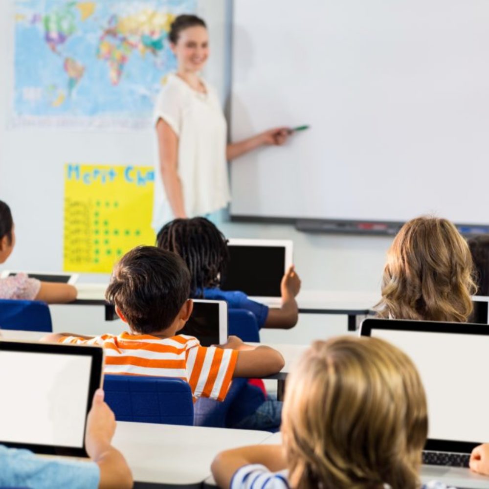 Schoolchildren using tablets against teacher